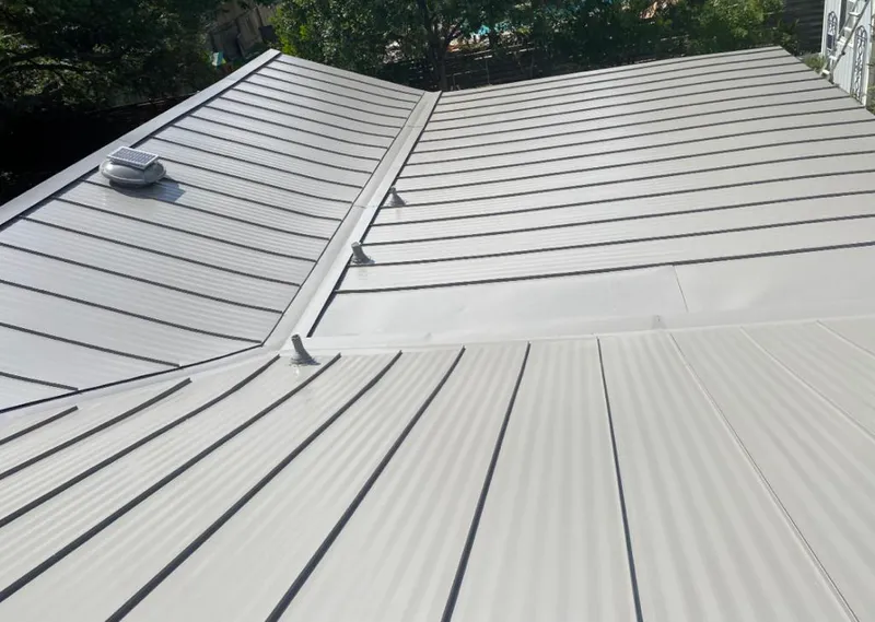 Solar attic fan installed on a metal roof for Roof Ventilation in Bolivar